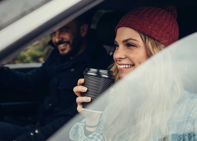 lady sitting in a car smiling